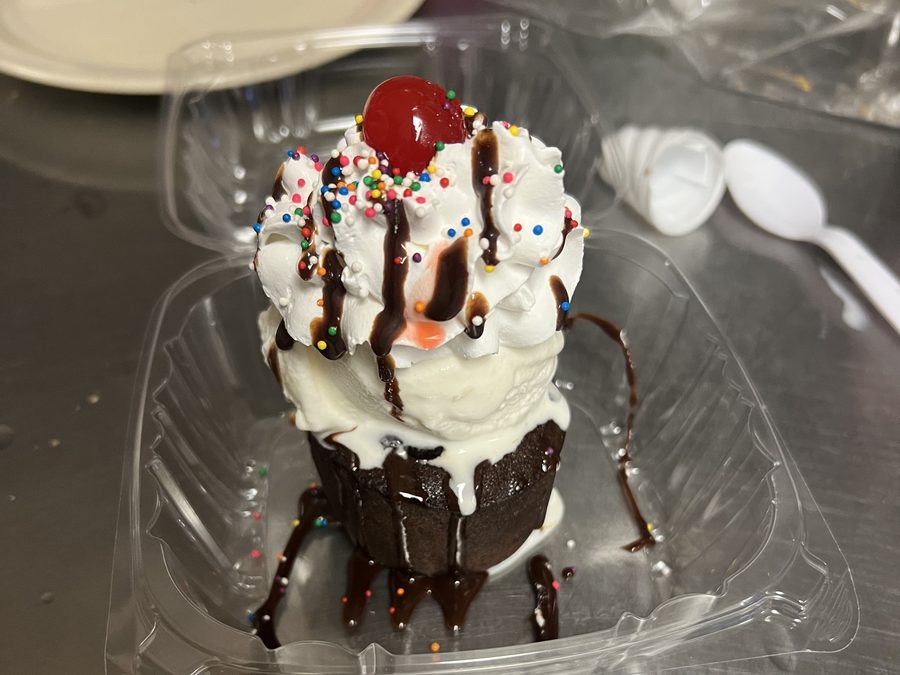 Mini lava cake with ice cream, whipped cream and cherry