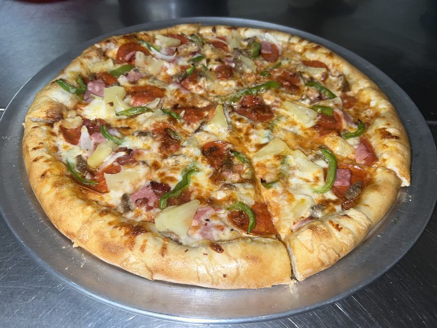 Supreme pizza with pepperoni, sausage, ham, pineapple and peppers